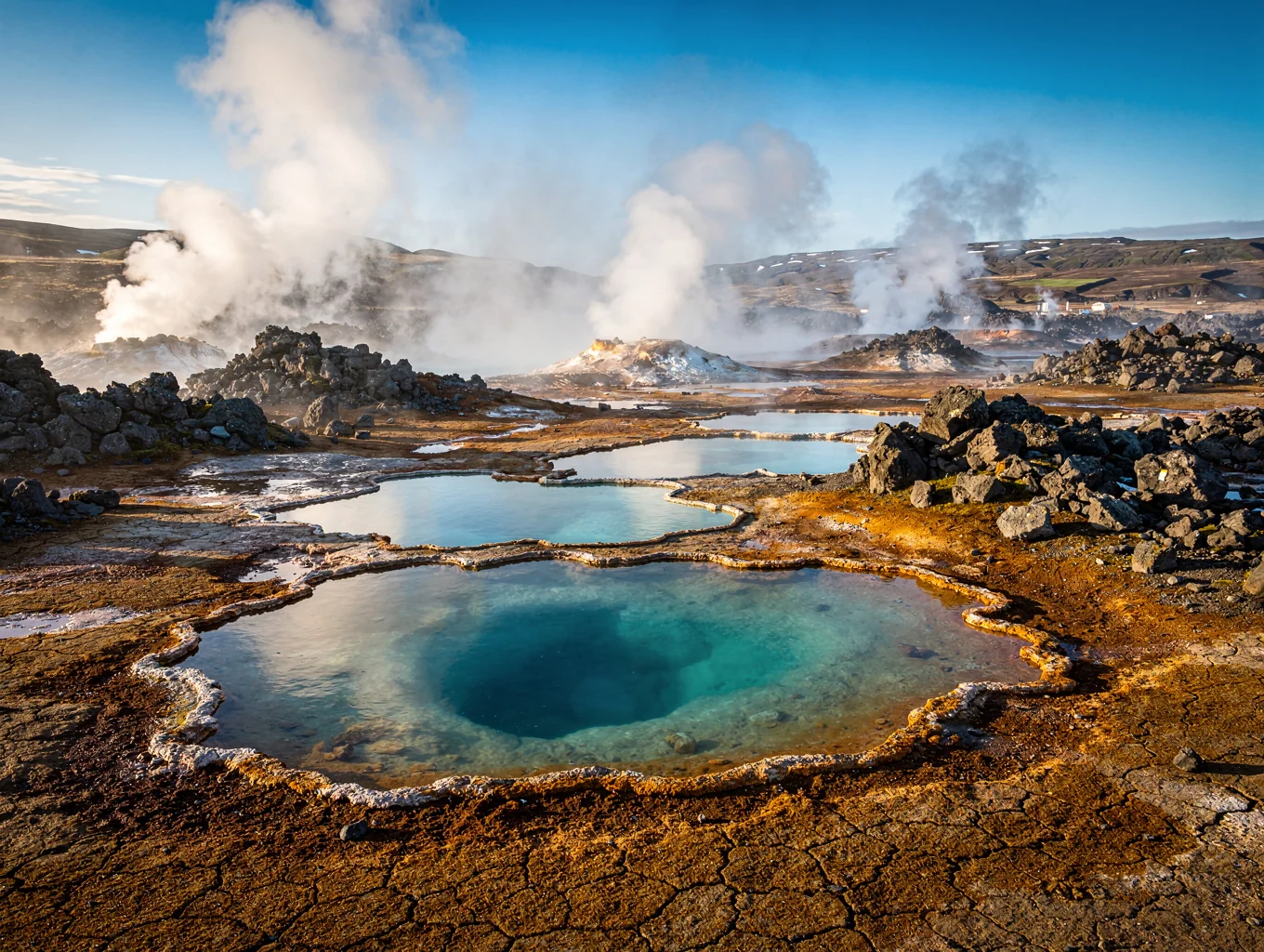 Volcanic caldera with turquoise water and steam