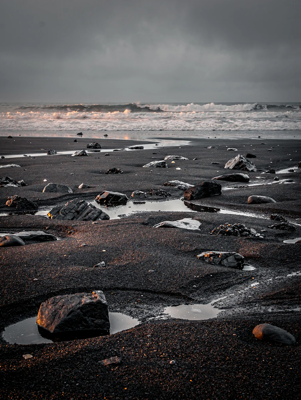 Ice fragments on black volcanic sand
