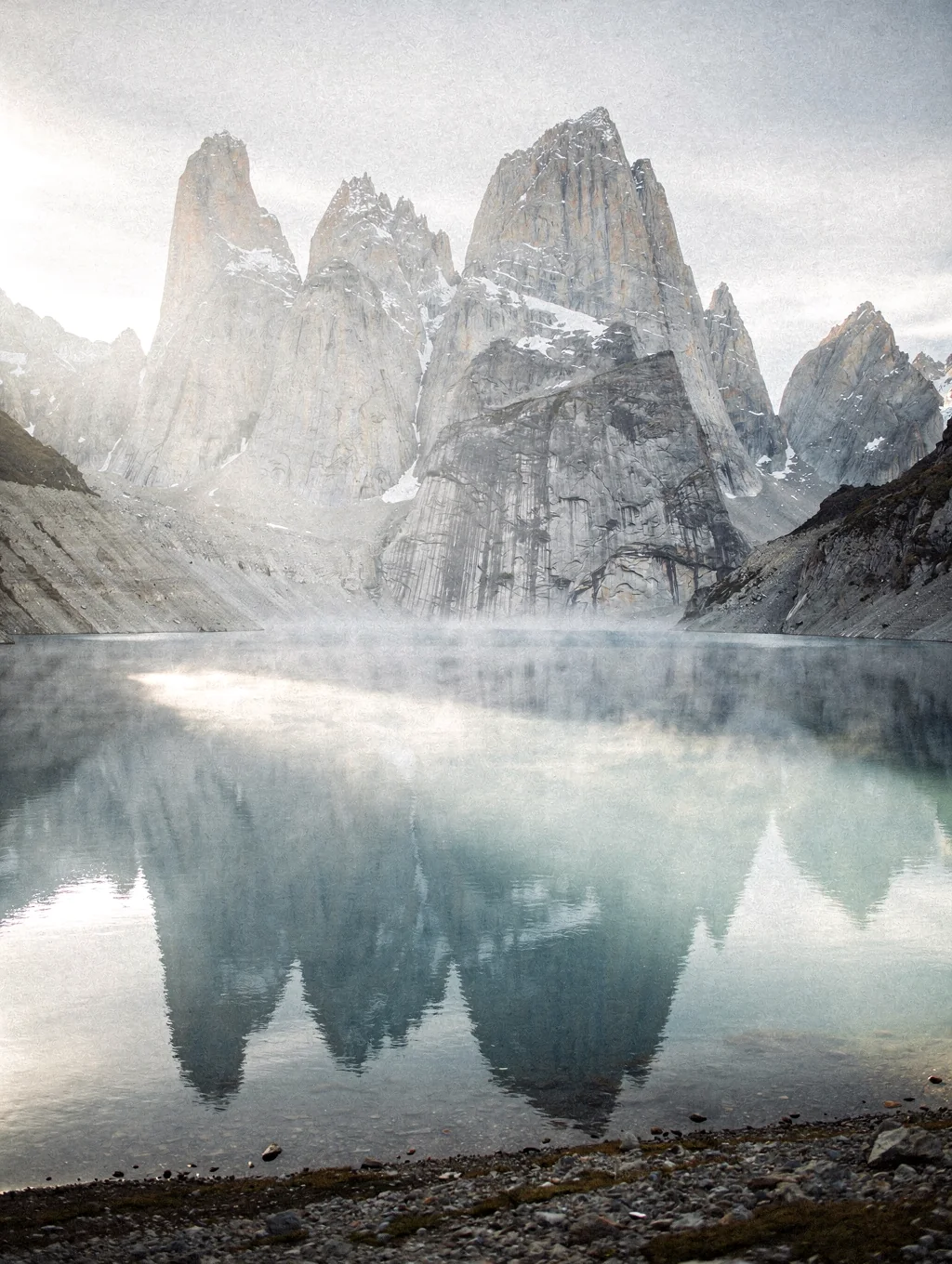 Granite peaks of Patagonia rising above glacial lakes at dawn